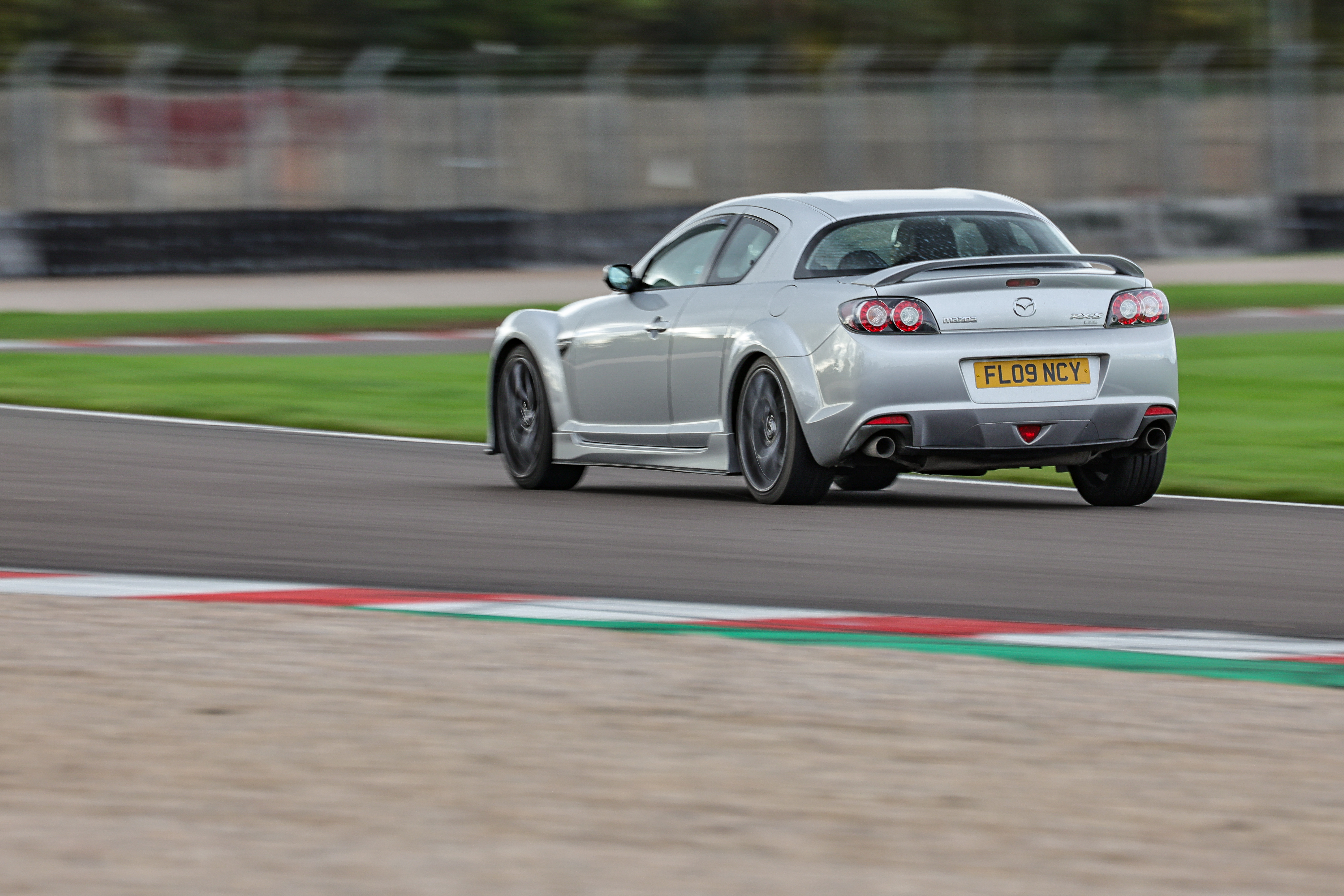 My silver Mazda RX8 R3 driving on the Donington Park race track.
